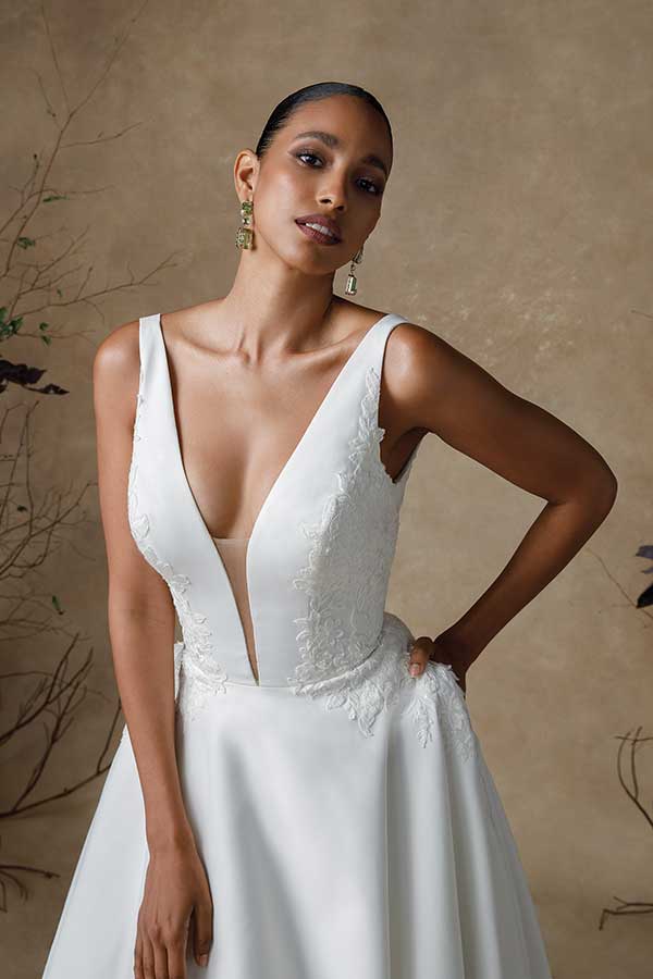 wedding dress with deep v and lace detailing on the sides