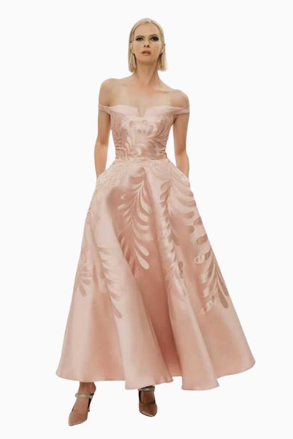 woman wearing pale-pink ankle length dress with a floral design