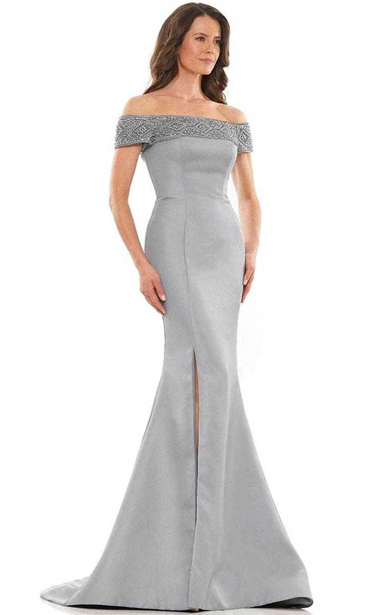 A woman in a grey evening gown with a slit.