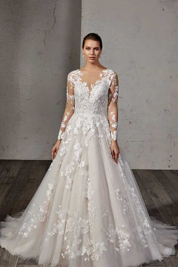 A wedding dress with a long sleeve and appliques.