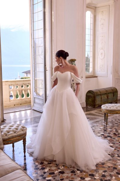 A woman wearing a white tulle wedding dress with a Basque waist. (2025 wedding dress trends)