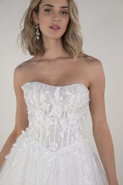 Woman wearing a wedding dress with a basque waist.