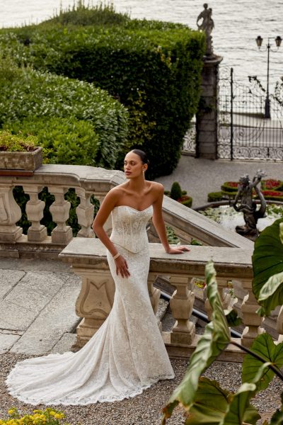 Woman on a balcony wearing a 2-piece wedding dress. (2025 wedding dress trends)