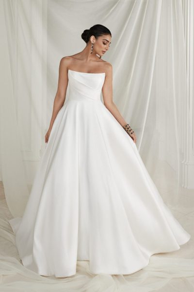 Woman wearing a simple a-line wedding dress with a cat-eye neckline (wedding dress trends)