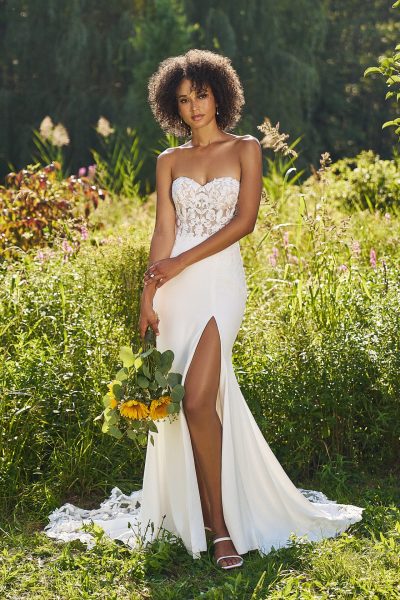 Woman wearing a strapless, fit and flare wedding dress with a high slit (wedding dress trends)